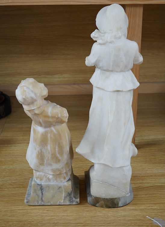 Two 20th century carved alabaster figures of young girls, one of a Dutch girl, the other larger, of a girl in a straw hat, 46cm high. Condition - Dutch girl good, girl with straw hat base broken to one corner